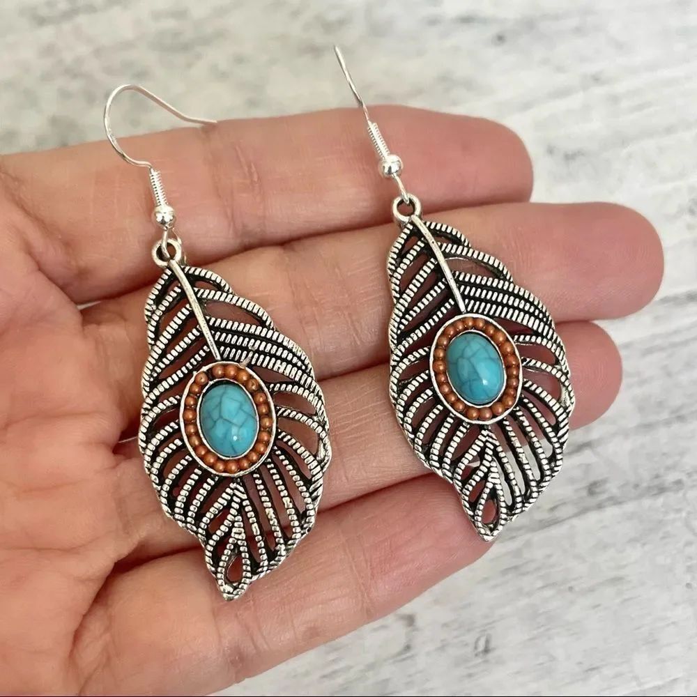 Silver tone feather and faux turquoise earrings